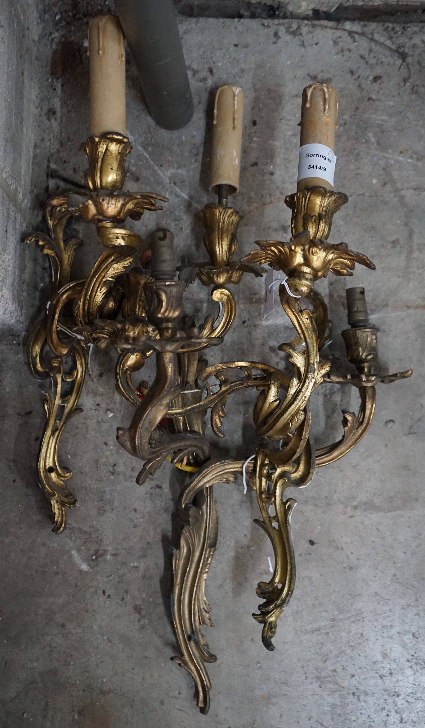 A set of three rococo style gilt metal twin branch wall lights, height 45cm